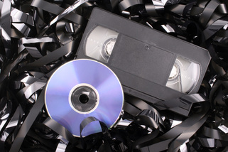 VHS tape set next to a DVD.